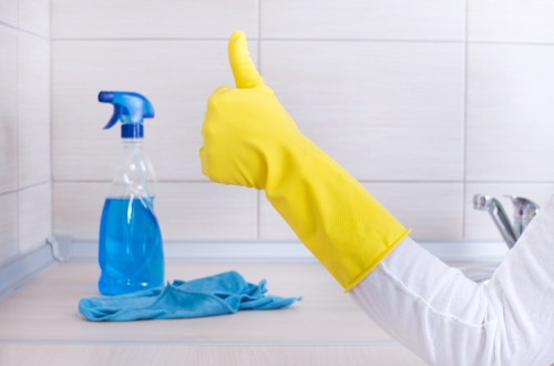 Technician performing upholstery cleaning on a sectional sofa